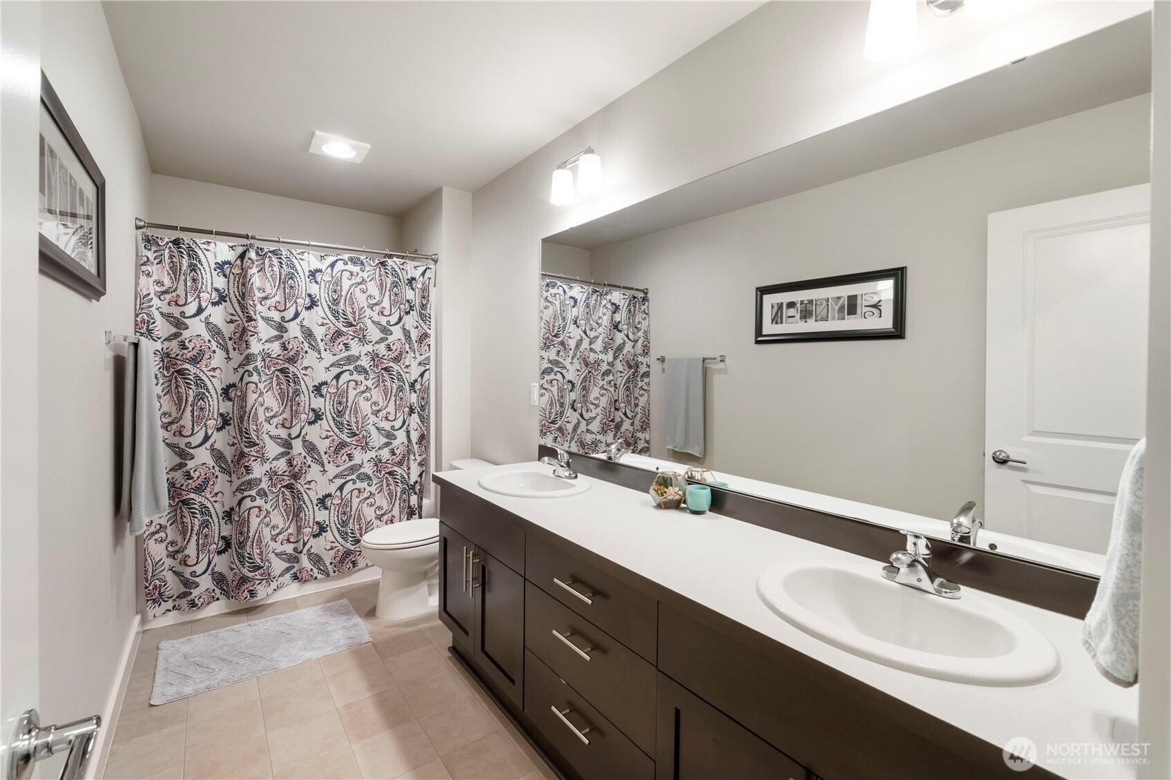 329 South Spruce Street Buckley, WA 98321 - Photo 26 of 36 a bathroom with a double vanity sink mirror and shower