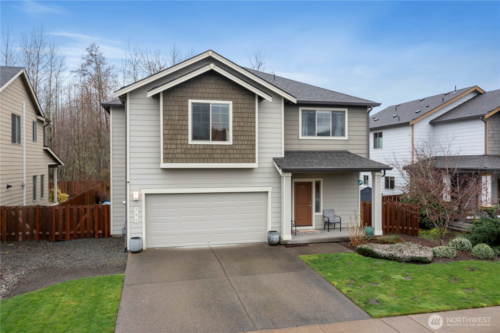 329 South Spruce Street Buckley, WA 98321 - Photo 28 of 36 a front view of a house with a yard and garage