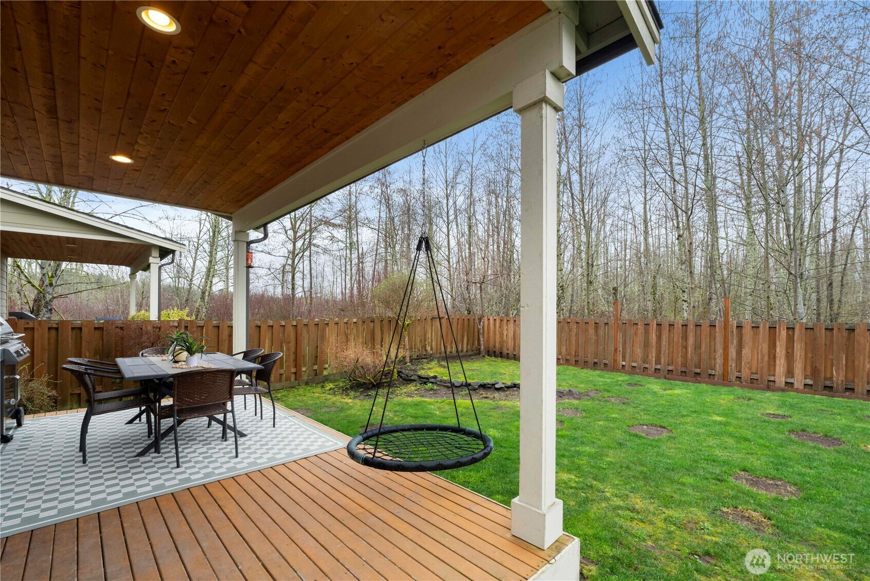 329 South Spruce Street Buckley, WA 98321 - Photo 30 of 36 a roof deck with table and chairs and wooden floor