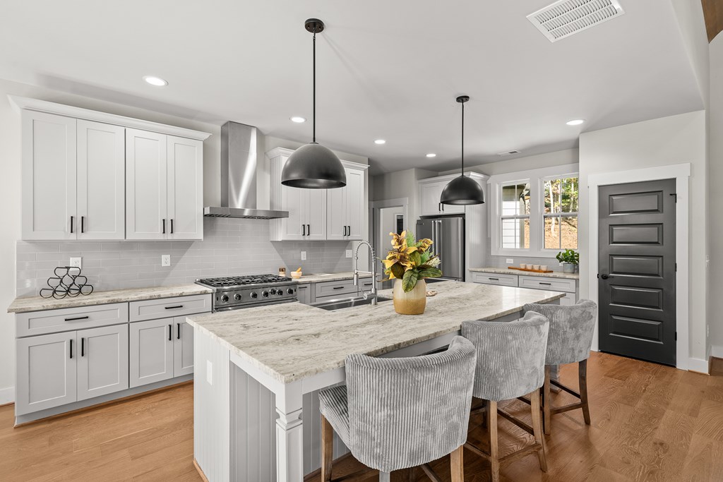 158 Treeline Lane Ellijay, GA 30540 - Photo 12 of 95 a kitchen with stainless steel appliances granite countertop a sink a stove and a wooden floors