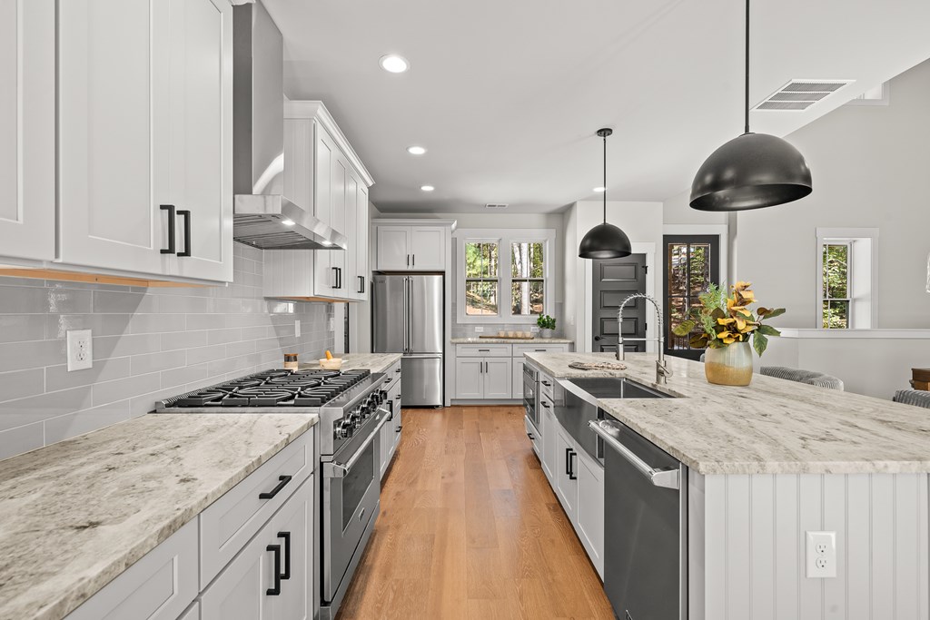 158 Treeline Lane Ellijay, GA 30540 - Photo 16 of 95 a kitchen with stainless steel appliances granite countertop a stove a sink a refrigerator and a wooden floors