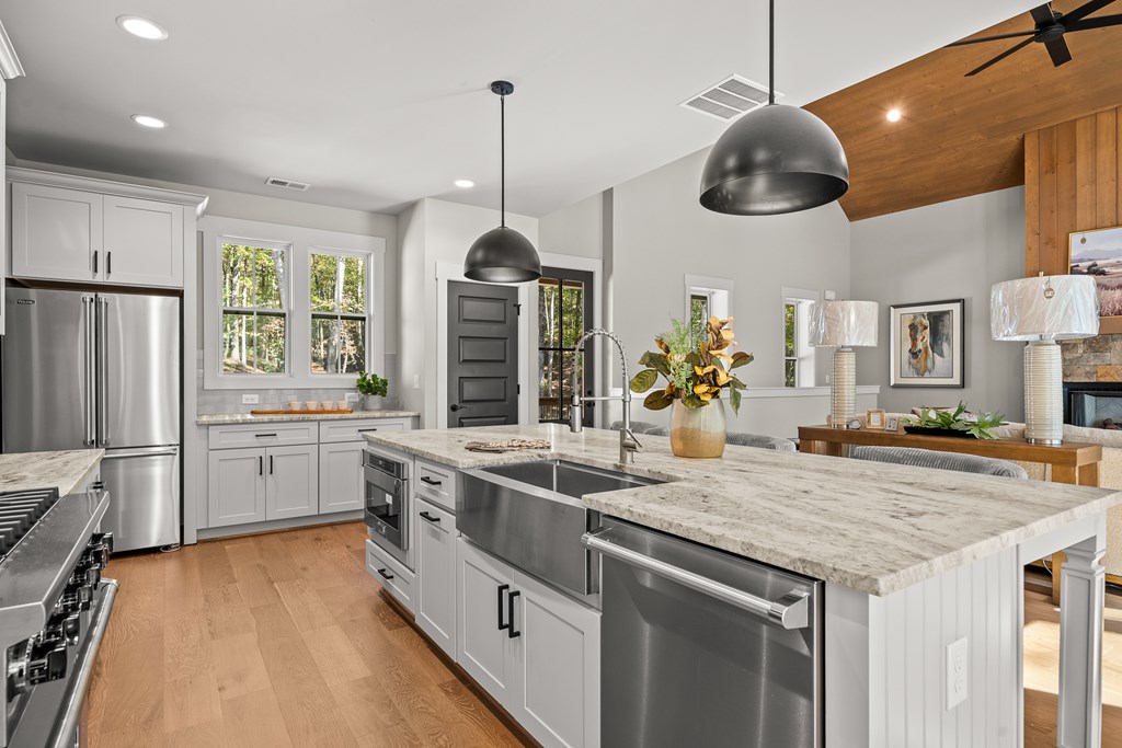 158 Treeline Lane Ellijay, GA 30540 - Photo 65 of 95 a kitchen with stainless steel appliances granite countertop a sink a stove and a refrigerator