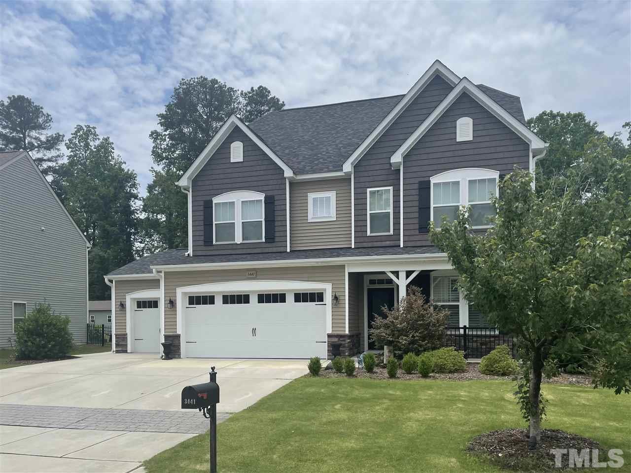 3441 Grosbeak Way Raleigh, NC 27616 - Photo 3 of 25 a front view of a house with a yard and garage
