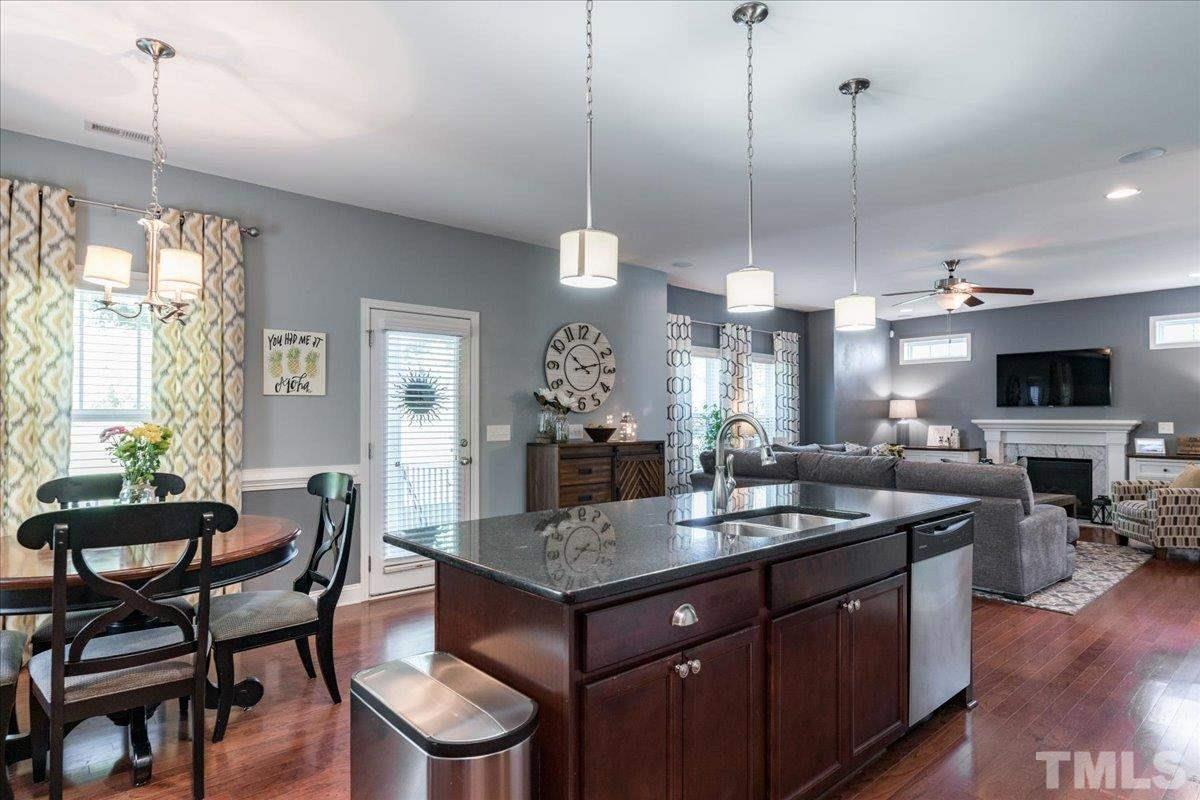 3441 Grosbeak Way Raleigh, NC 27616 - Photo 8 of 25 a dining table chairs and a chandelier
