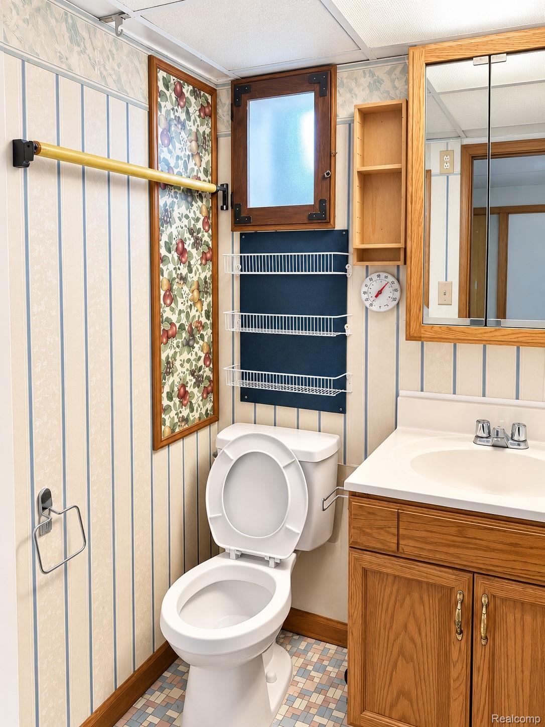 4529 Frazho Road Warren, MI 48091 - Photo 6 of 9 Bathroom with wood-finish vanity, integrated sink, and coordinated wood-finish medicine cabinet