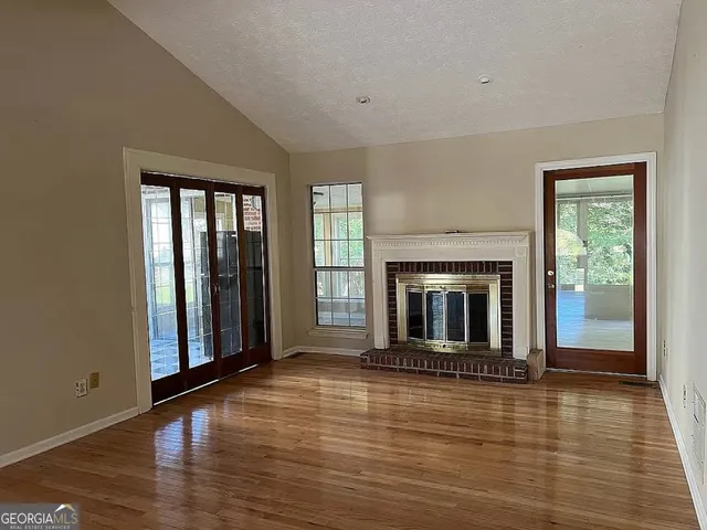 wooden floor fireplace and windows in a room