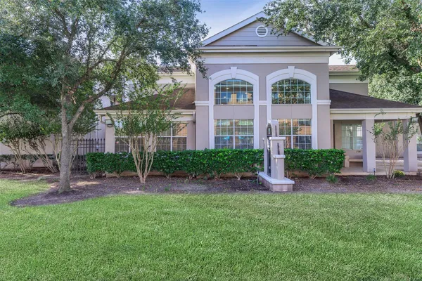 a front view of a house with a yard and outdoor seating