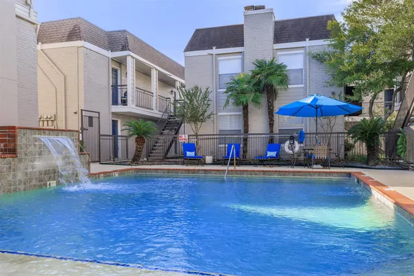 a view of a building with sitting area and garden