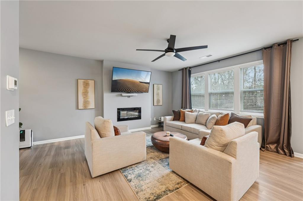 95 Denver Avenue Hiram, GA 30141 - Photo 11 of 62 a living room with furniture a fireplace and a flat screen tv
