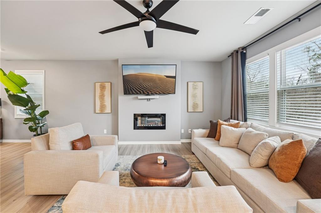 95 Denver Avenue Hiram, GA 30141 - Photo 12 of 62 a living room with furniture a fireplace and a flat screen tv