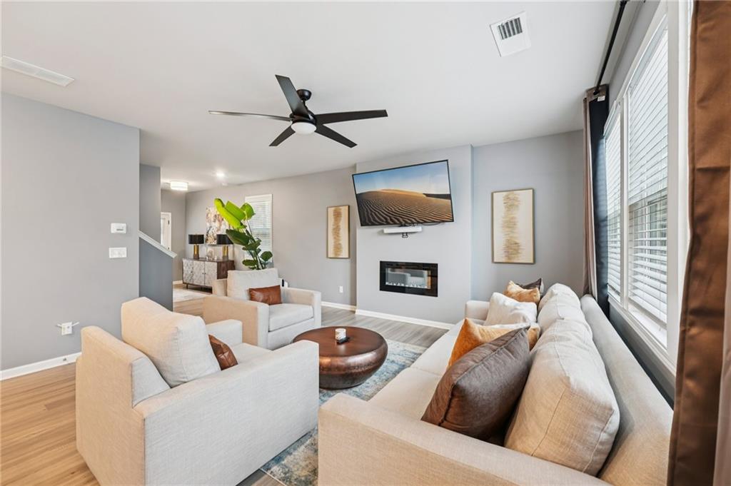 95 Denver Avenue Hiram, GA 30141 - Photo 13 of 62 a living room with furniture a fireplace and a flat screen tv