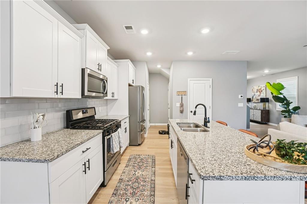 95 Denver Avenue Hiram, GA 30141 - Photo 22 of 62 a large kitchen with granite countertop a sink and cabinets