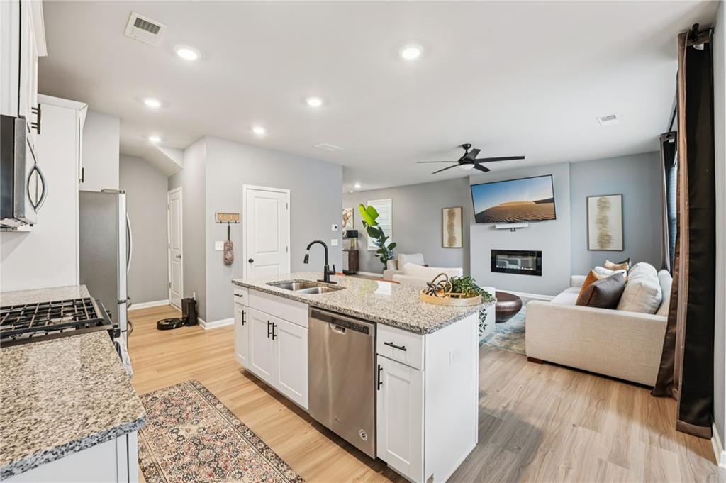 95 Denver Avenue Hiram, GA 30141 - Photo 23 of 62 a kitchen with a sink stove and refrigerator