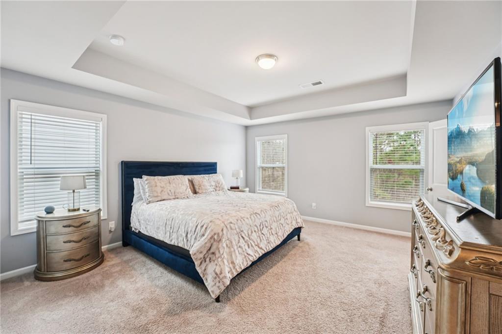 95 Denver Avenue Hiram, GA 30141 - Photo 26 of 62 a bedroom with a bed and a flat tv screen on dresser