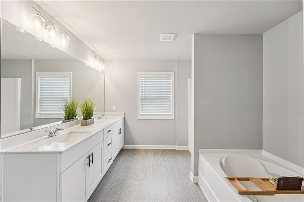 95 Denver Avenue Hiram, GA 30141 - Photo 30 of 62 a bathroom with a tub sink and mirror