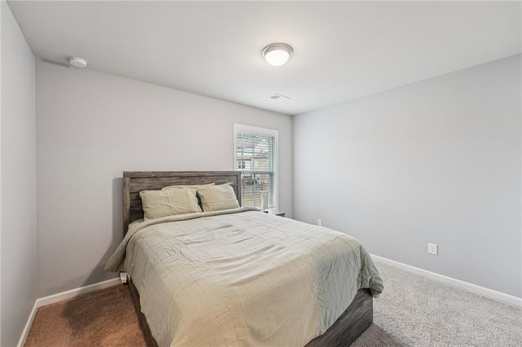 95 Denver Avenue Hiram, GA 30141 - Photo 35 of 62 a bedroom with a bed and a night stand