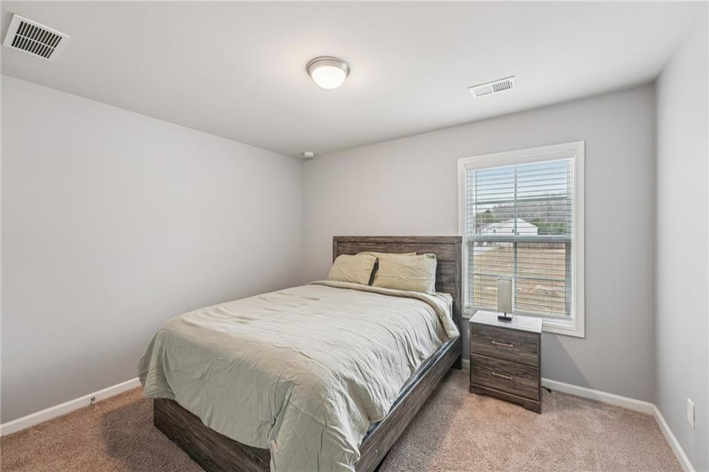 95 Denver Avenue Hiram, GA 30141 - Photo 36 of 62 a large bed sitting in a bedroom next to a window