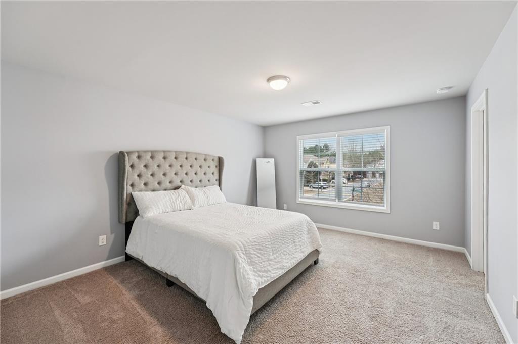 95 Denver Avenue Hiram, GA 30141 - Photo 39 of 62 a bed sitting in a bedroom next to a window