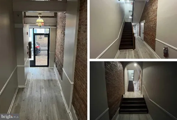 a view of a hallway with wooden floor and staircase