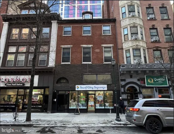 a couple of cars parked in front of a building