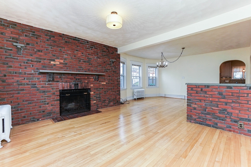 51 Wallingford Road Boston, MA 02135 - Photo 13 of 42 a room with fireplace and wooden floor