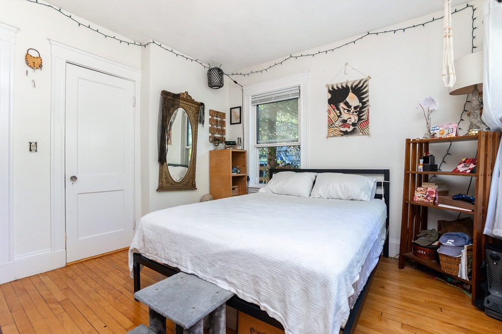 51 Wallingford Road Boston, MA 02135 - Photo 20 of 42 a bedroom with a bed and wooden floor