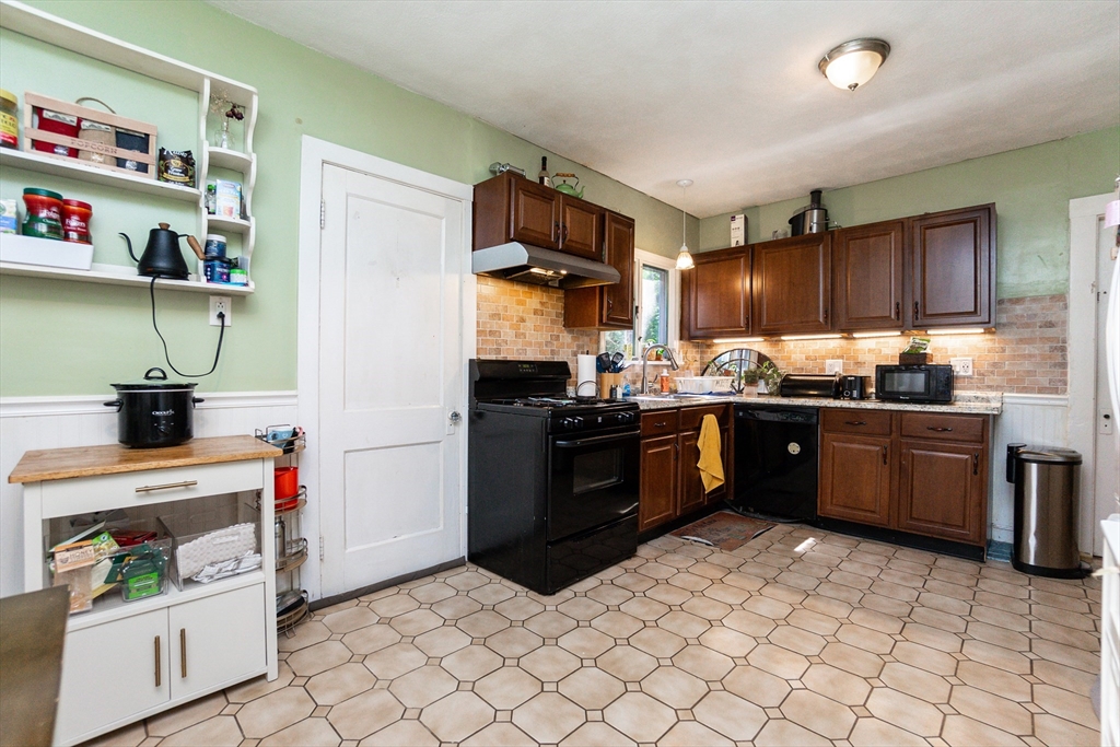 51 Wallingford Road Boston, MA 02135 - Photo 21 of 42 a kitchen with stainless steel appliances granite countertop a refrigerator and a stove top oven
