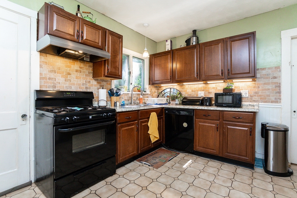 51 Wallingford Road Boston, MA 02135 - Photo 22 of 42 a kitchen with a sink stove and cabinets
