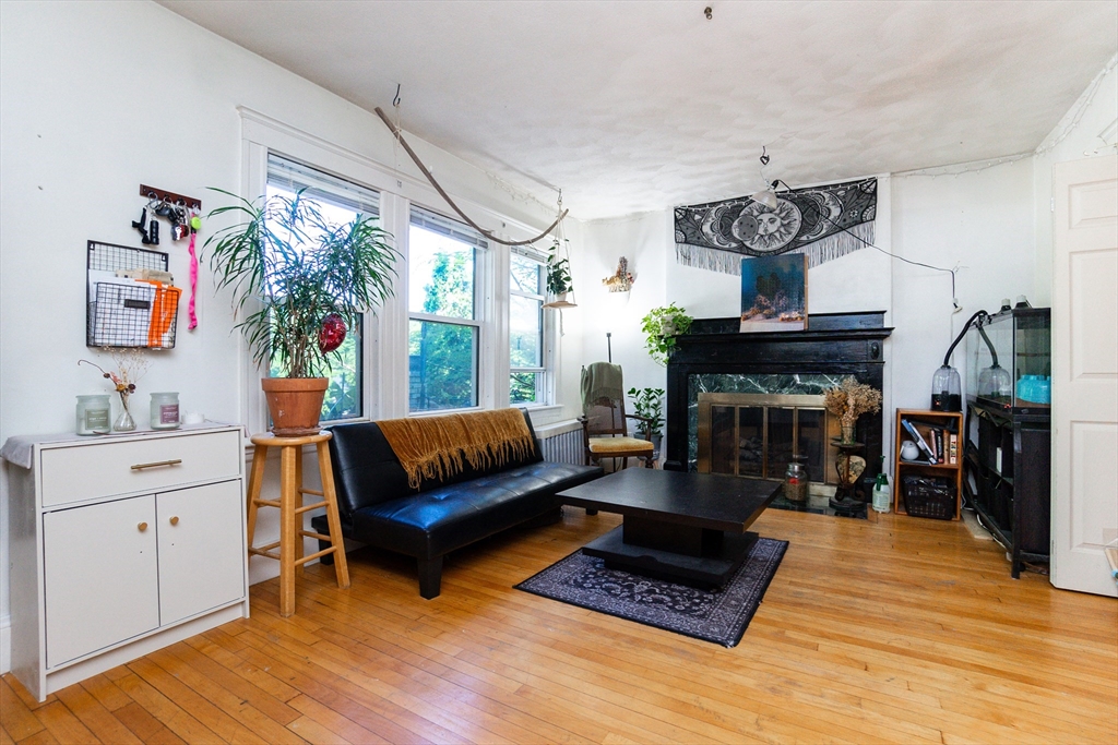 51 Wallingford Road Boston, MA 02135 - Photo 23 of 42 a living room with furniture and a fireplace