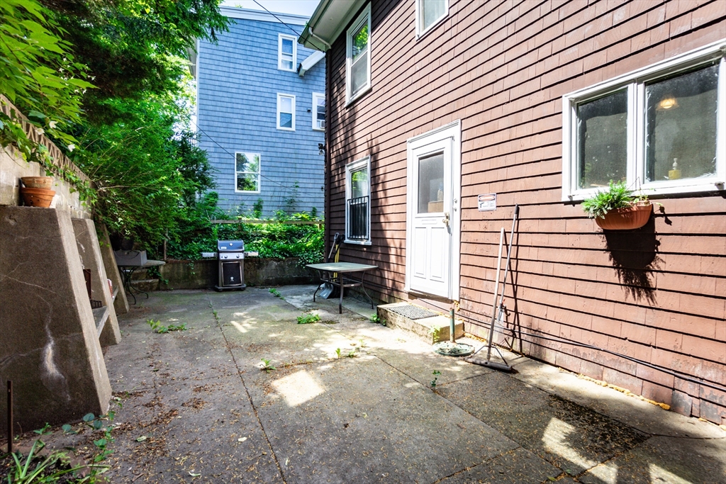51 Wallingford Road Boston, MA 02135 - Photo 25 of 42 a view of a house with backyard and sitting area