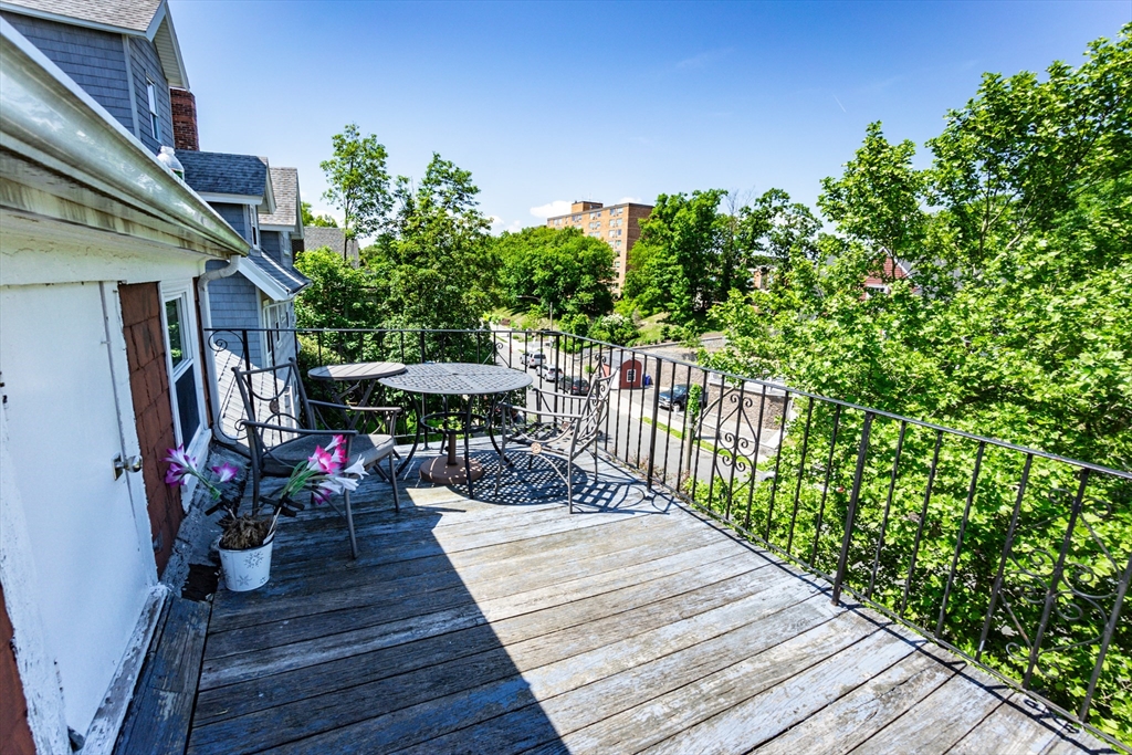 51 Wallingford Road Boston, MA 02135 - Photo 27 of 42 a balcony with furniture and a potted plant