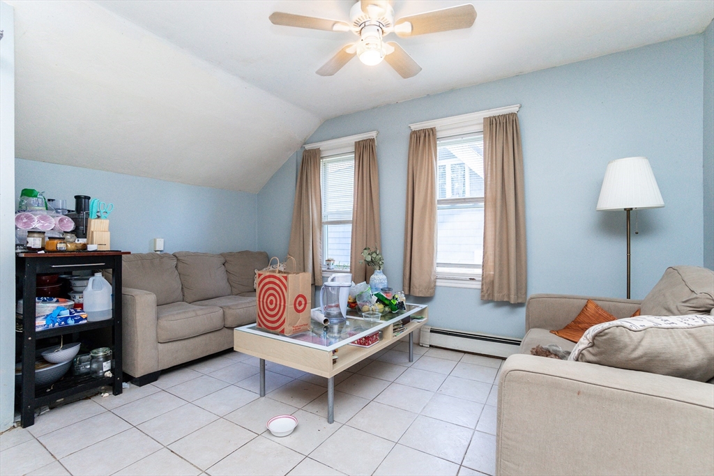 51 Wallingford Road Boston, MA 02135 - Photo 28 of 42 a living room with furniture and a chandelier
