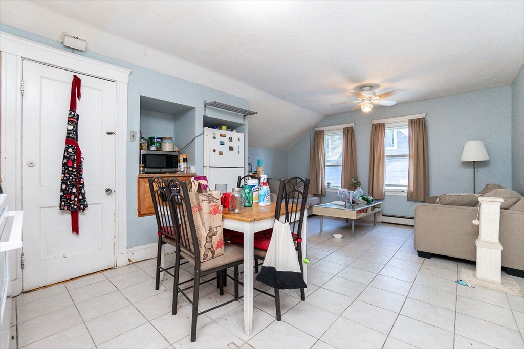 51 Wallingford Road Boston, MA 02135 - Photo 30 of 42 a living room with furniture and a chandelier