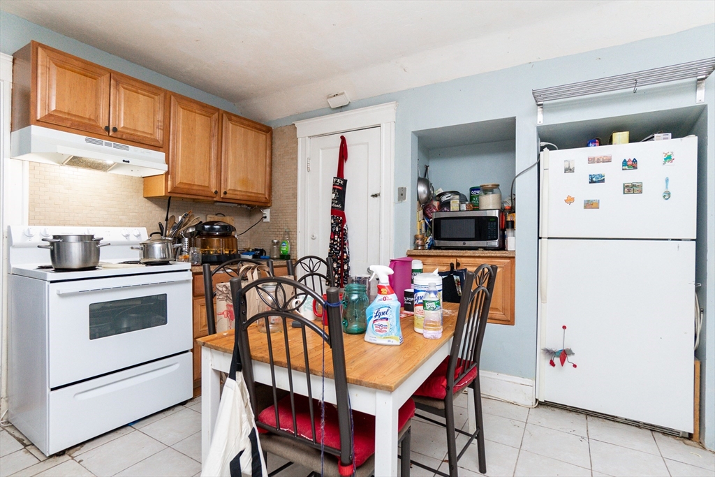 51 Wallingford Road Boston, MA 02135 - Photo 31 of 42 a kitchen with stainless steel appliances granite countertop a refrigerator and a stove top oven