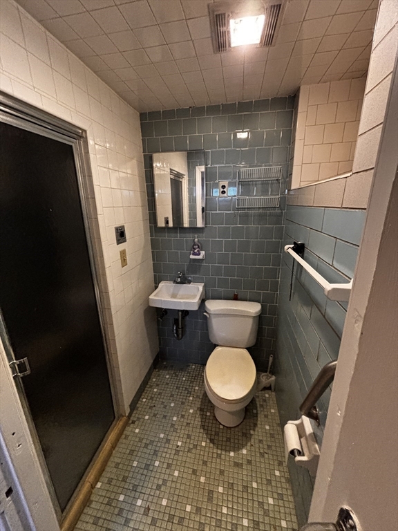 51 Wallingford Road Boston, MA 02135 - Photo 36 of 42 a bathroom with a sink toilet and shower