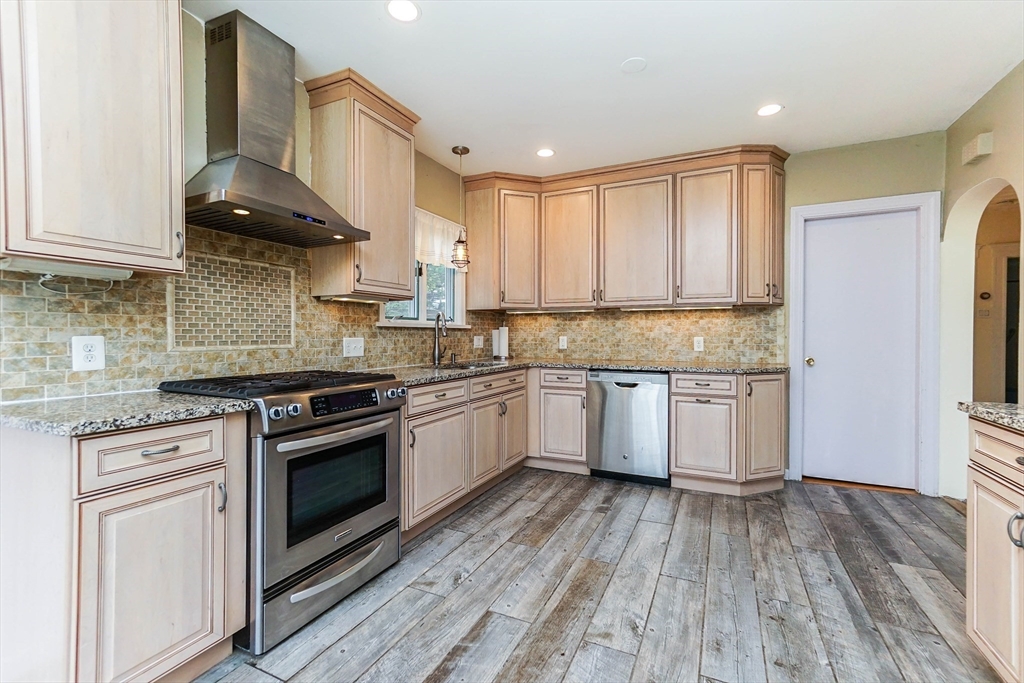 51 Wallingford Road Boston, MA 02135 - Photo 5 of 42 a kitchen with stainless steel appliances granite countertop a stove a sink and a refrigerator