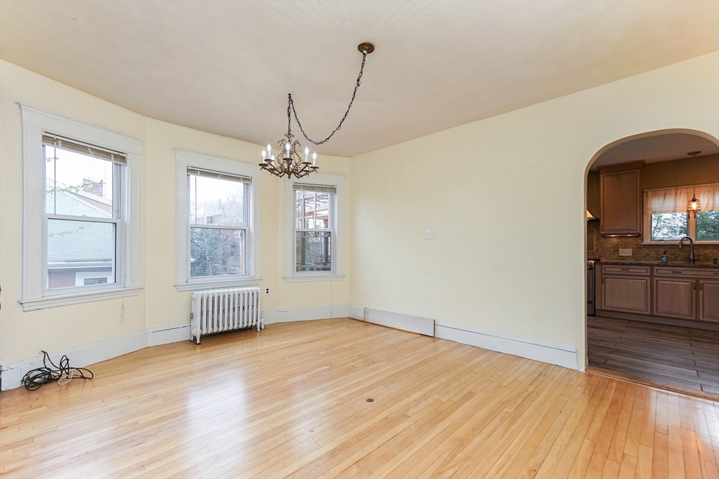 51 Wallingford Road Boston, MA 02135 - Photo 8 of 42 a view of a room with wooden floor and windows