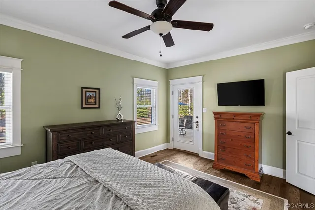 a bedroom with a bed and a flat tv screen on dresser