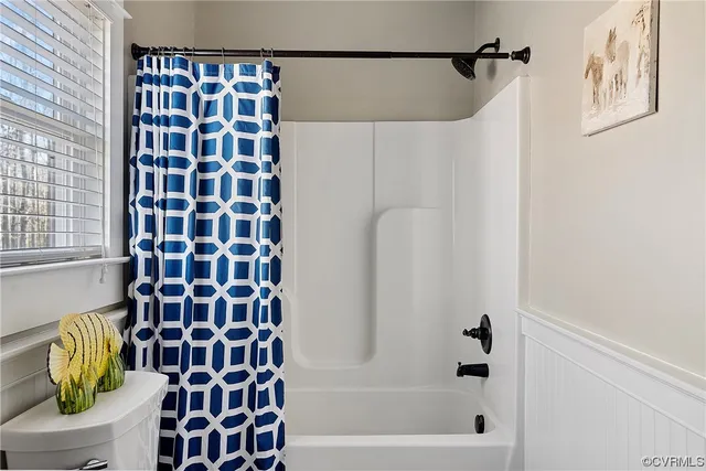 a bathroom with a bathtub and shower