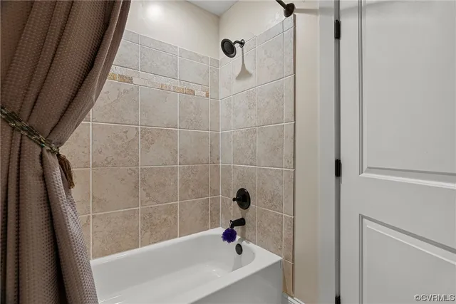 a bathroom with a sink a window and shower