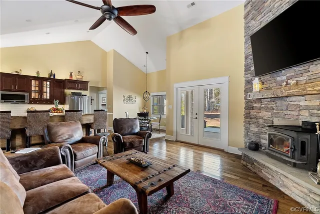 a living room with furniture a flat screen tv and a fireplace