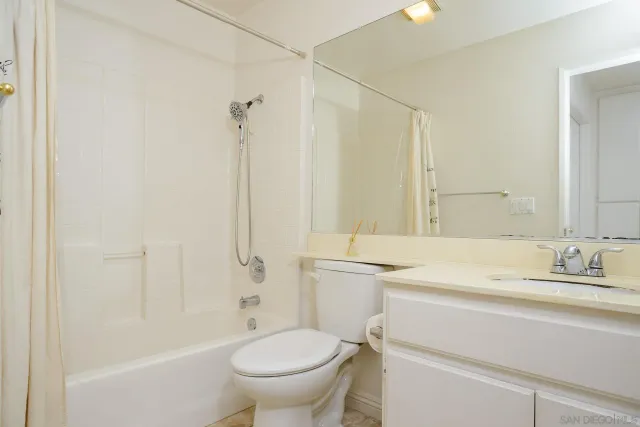 a bathroom with a sink toilet vanity and shower