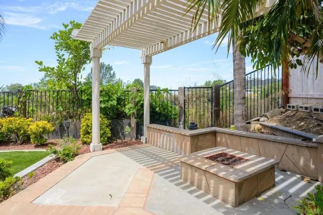 a view of a backyard with plants and a patio