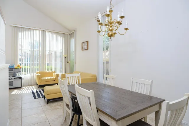 a dining room with furniture and chandelier