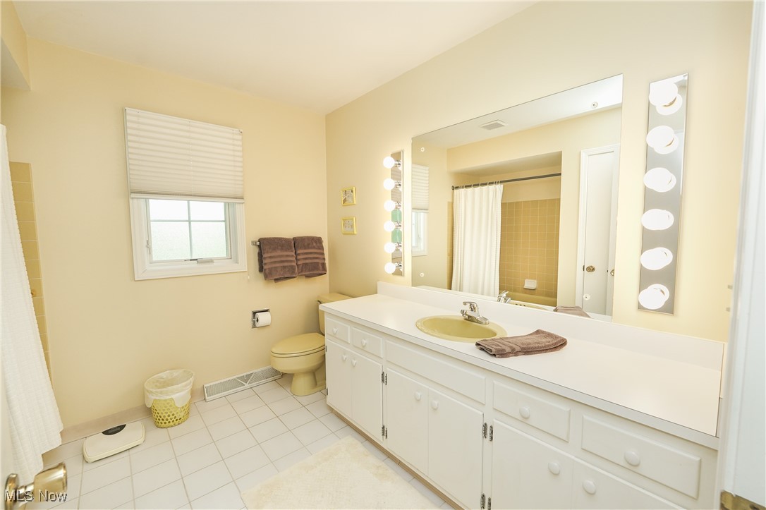 817 Rickel Circle Akron, OH 44333 - Photo 30 of 49 Bathroom featuring toilet, ceramic tile floors, baseboards, vanity, and a shower with shower curtain