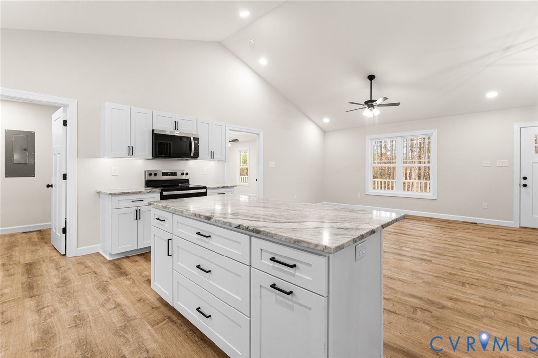 5132 Sunnyside Road Tappahannock, VA 22560 - Photo 12 of 28 a kitchen with granite countertop a sink appliances cabinets and a counter top space