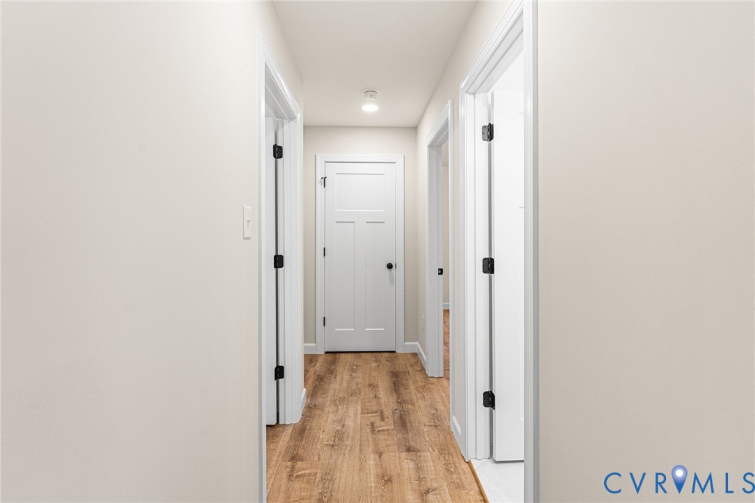 5132 Sunnyside Road Tappahannock, VA 22560 - Photo 20 of 28 a view of a hallway with wooden floor