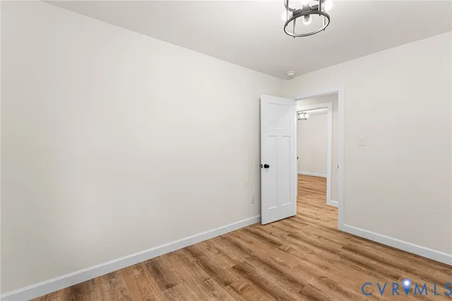 a view of a room with wooden floor and white walls