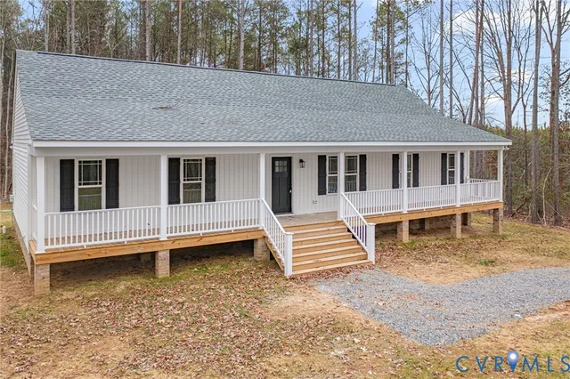 a view of a house with a wooden deck and a yard