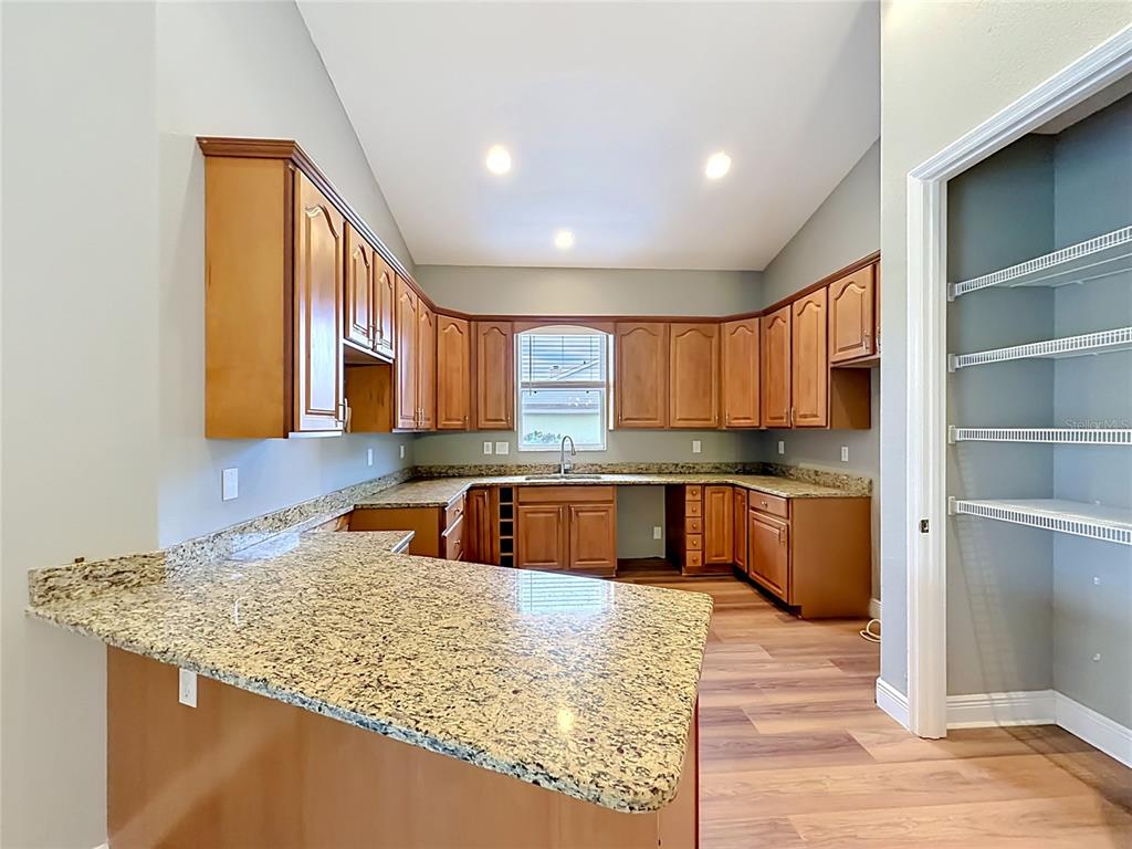 28549 Shirley Shores Road Tavares, FL 32778 - Photo 18 of 65 a kitchen with stainless steel appliances granite countertop a sink a stove and a refrigerator